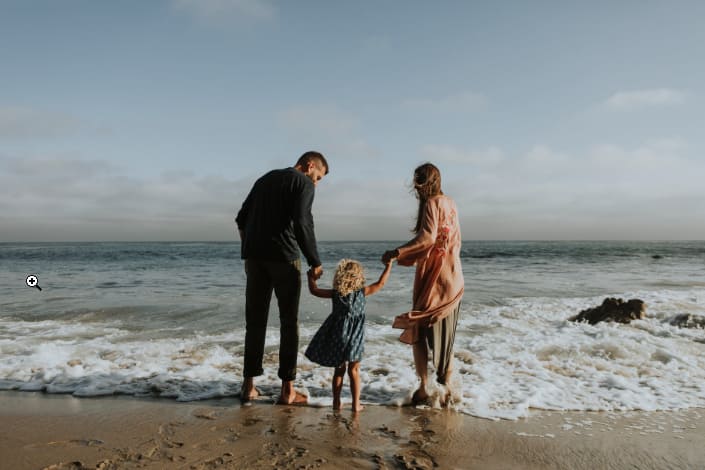 a family playing on the beach